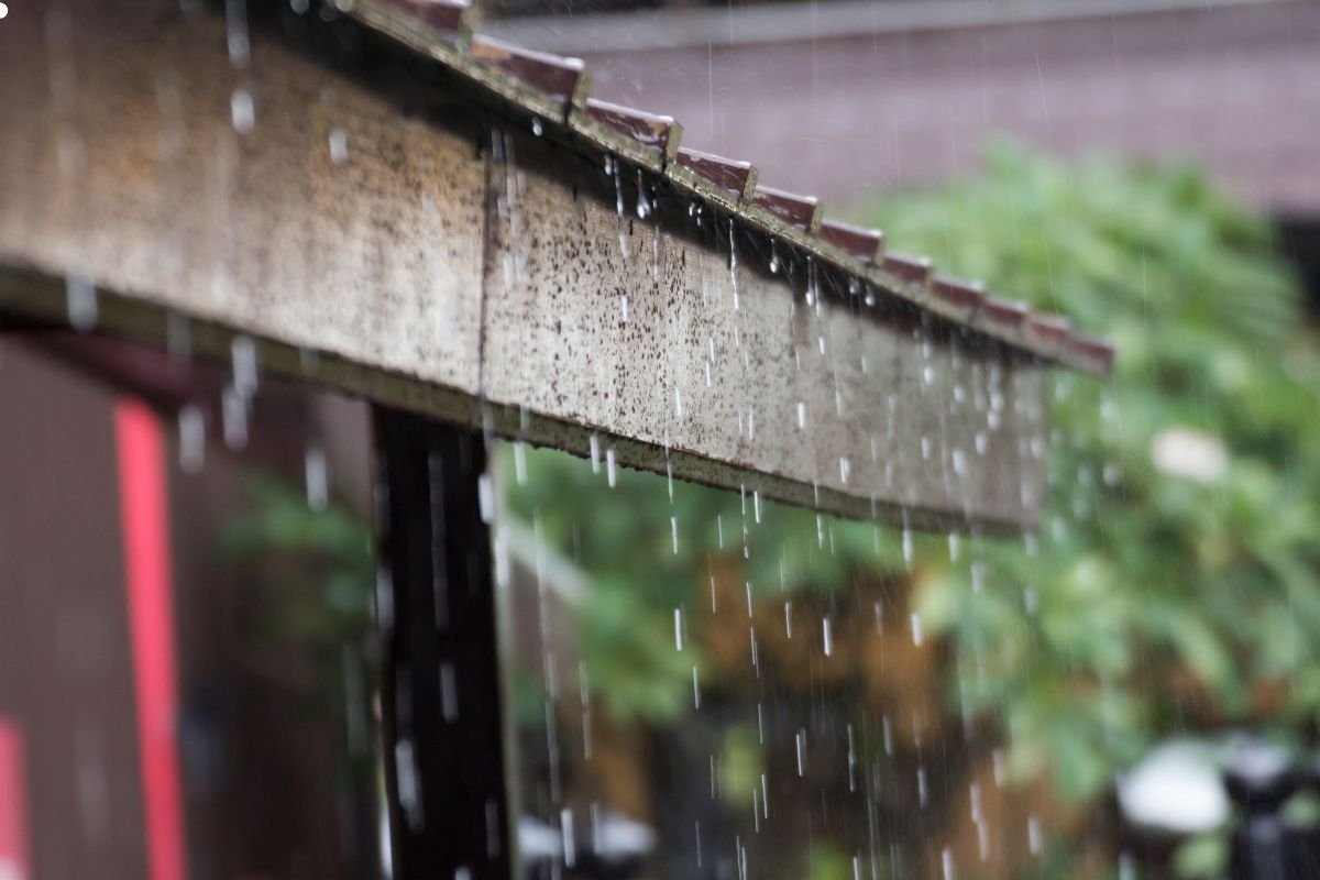 Rain gently falls on a rustic wooden roof, creating a soothing ambiance and a serene atmosphere.
